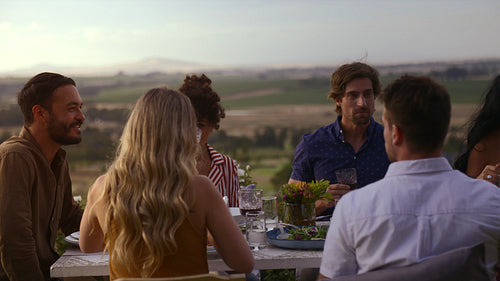 Friends enjoying having dinner together