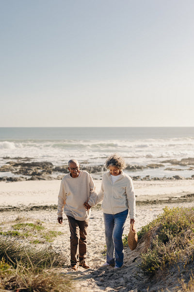 Mature couple leaving the beach after a picnic