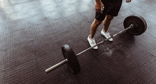 Man exercising with barbell at gym
