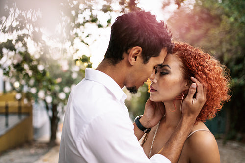 Young couple in a sensual pose outdoors.