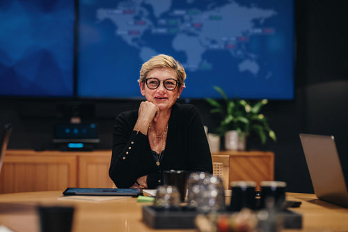 Businesswoman sitting at boardroom table