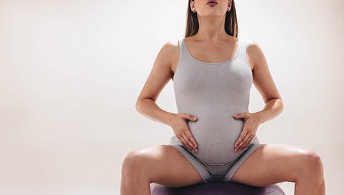 Expecting mother finding wellness and strength through prenatal yoga and exercise