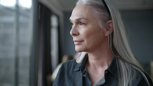 Senior businesswoman standing in office and looking away