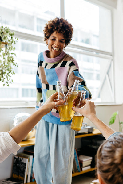 Colleagues toasting drinks in a bright co-working space