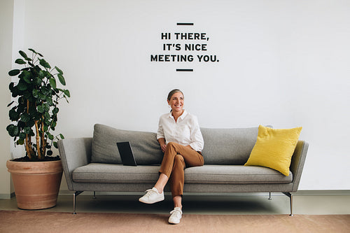 Happy female entrepreneur at office lobby