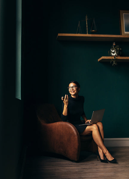 Business female with laptop talking on mobile phone