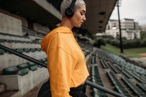 Fitness woman walking down the stairs of a stadium