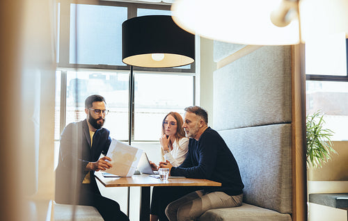 Entrepreneurs discussing and important report