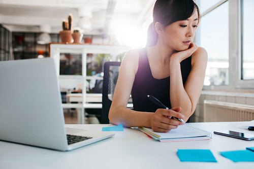 Young asian woman working at her desk