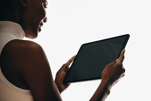 Person using a digital tablet in silhouette view