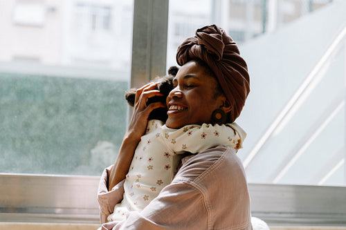 Woman joyfully holding her baby
