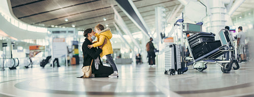 Happy mother and son meeting at airport after pandemic