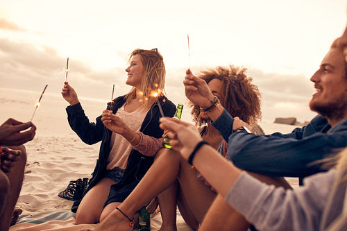 Group of friends celebrating new year's day at the beach