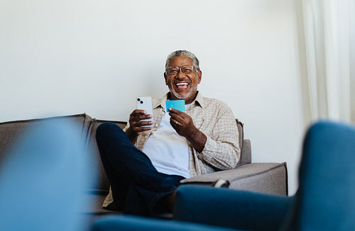 Technology Adoption: Confident senior man shopping online