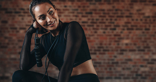 Fitness woman relaxing after exercising at gym