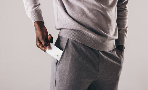 Business man with a private bank account putting is platinum credit card in his pocket