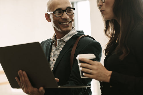 Smiling businessman with female colleague in office