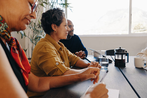 Team engaging in a board meeting in a bright contemporary office setting