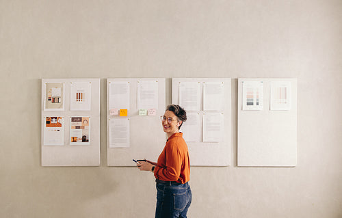 Happy businesswoman smiling at the camera in a creative office