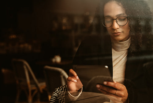 Businesswoman at a cafe using digital tablet