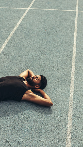 Athlete relaxing after the race on running track