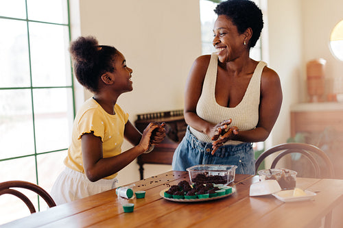 Daughter her mom making traditional Brazilian brigadeiro candy