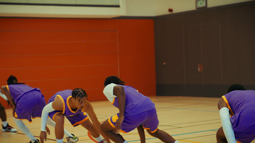 Young men training on basketball court