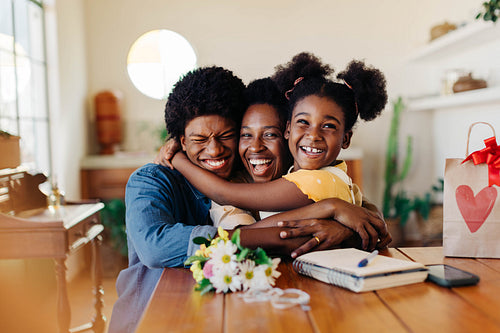 Happy mother's day celebration with a cheerful brazilian family giving gifts and flowers at home