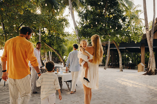 Family walking to beachfront dining experience at luxury resort