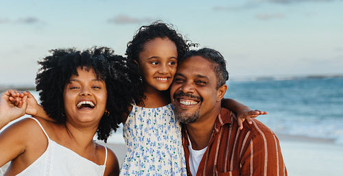 Happy Brazilian family enjoying time together at the beach