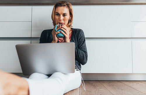 Woman working on laptop computer at home