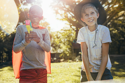 happy boys playing water guns outdoors