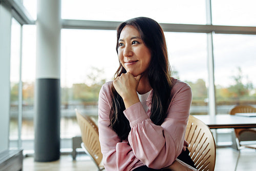 Woman in business casuals sitting in office