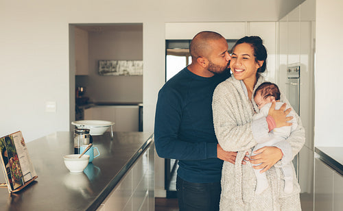 Beautiful young family in kitchen