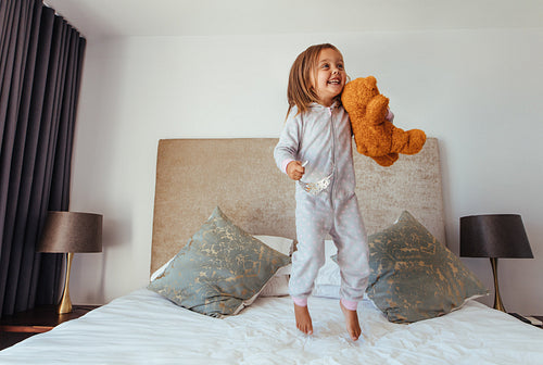 Little girl playing in bedroom
