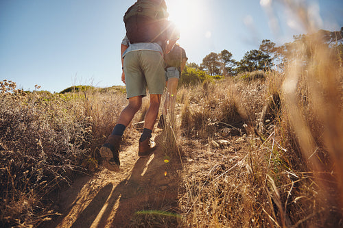 Young hikers climbing uphill on a mountain