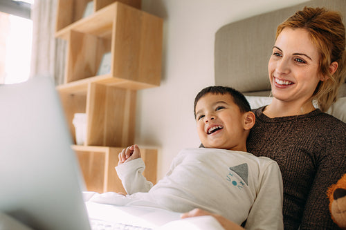Young family watching cartoon on laptop