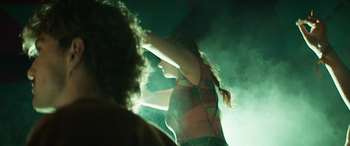 Woman dances on shoulders of friend at festival