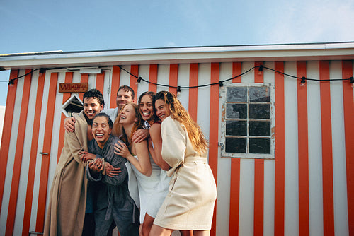 Friends embracing outside bathhouse after cold plunge retreat