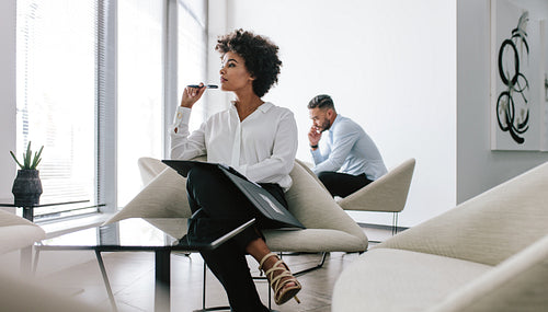 Woman working in modern office lobby