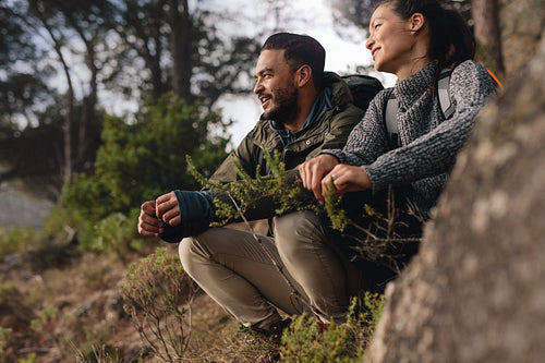 Couple taking a break after hiking uphill in the countryside