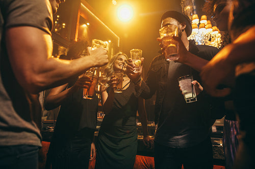 People at nightclub enjoying with cocktails