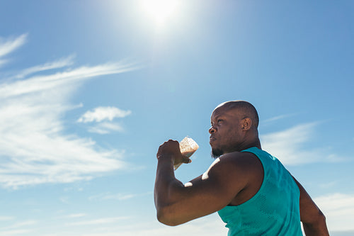 Athlete drinking health drink during workout outdoors