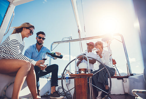 Group of friends drinking wine on a yacht