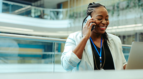 Confident businesswoman enjoying a phone call in modern office