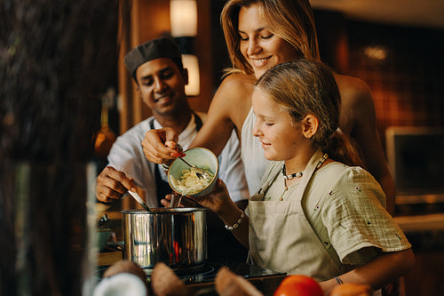 Family cooking lesson in a modern kitchen with fresh ingredients