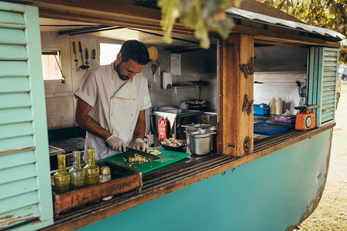 Man cooking in a mobile food truck