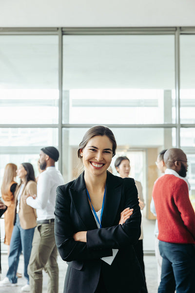 Successful businesswoman at corporate conference with colleagues in background
