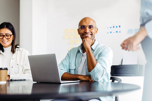 Male designer sitting in a team meeting