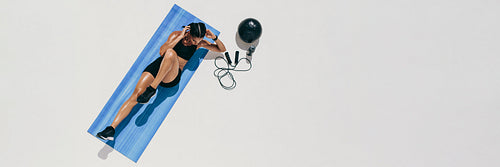 Fitness woman doing workout on a yoga mat